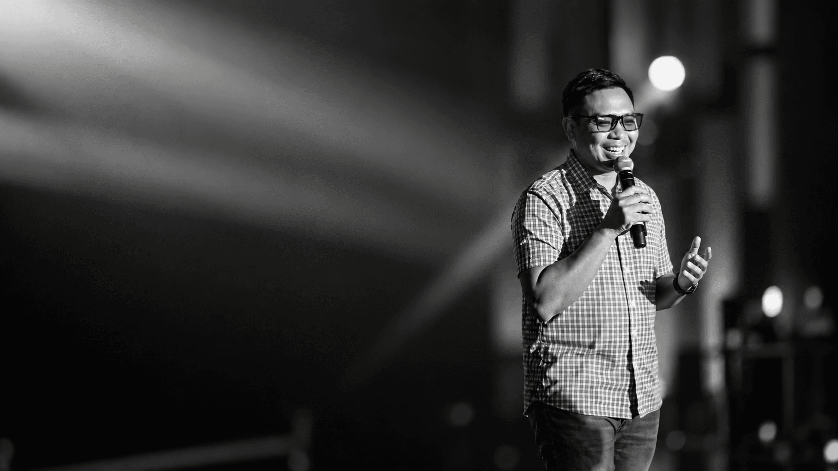 Luis Yu speaking onstage